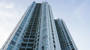 A tall, modern high-rise building with multiple balconies and large windows. - Elegant And Homey 2Br Apartment At Puri Casablanca (Jakarta)