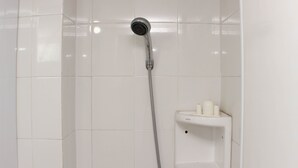 A shower with a handheld showerhead and a wall-mounted control panel. - Nice And Comfortable Studio At Bassura City Apartment Near Mall (Jakarta)