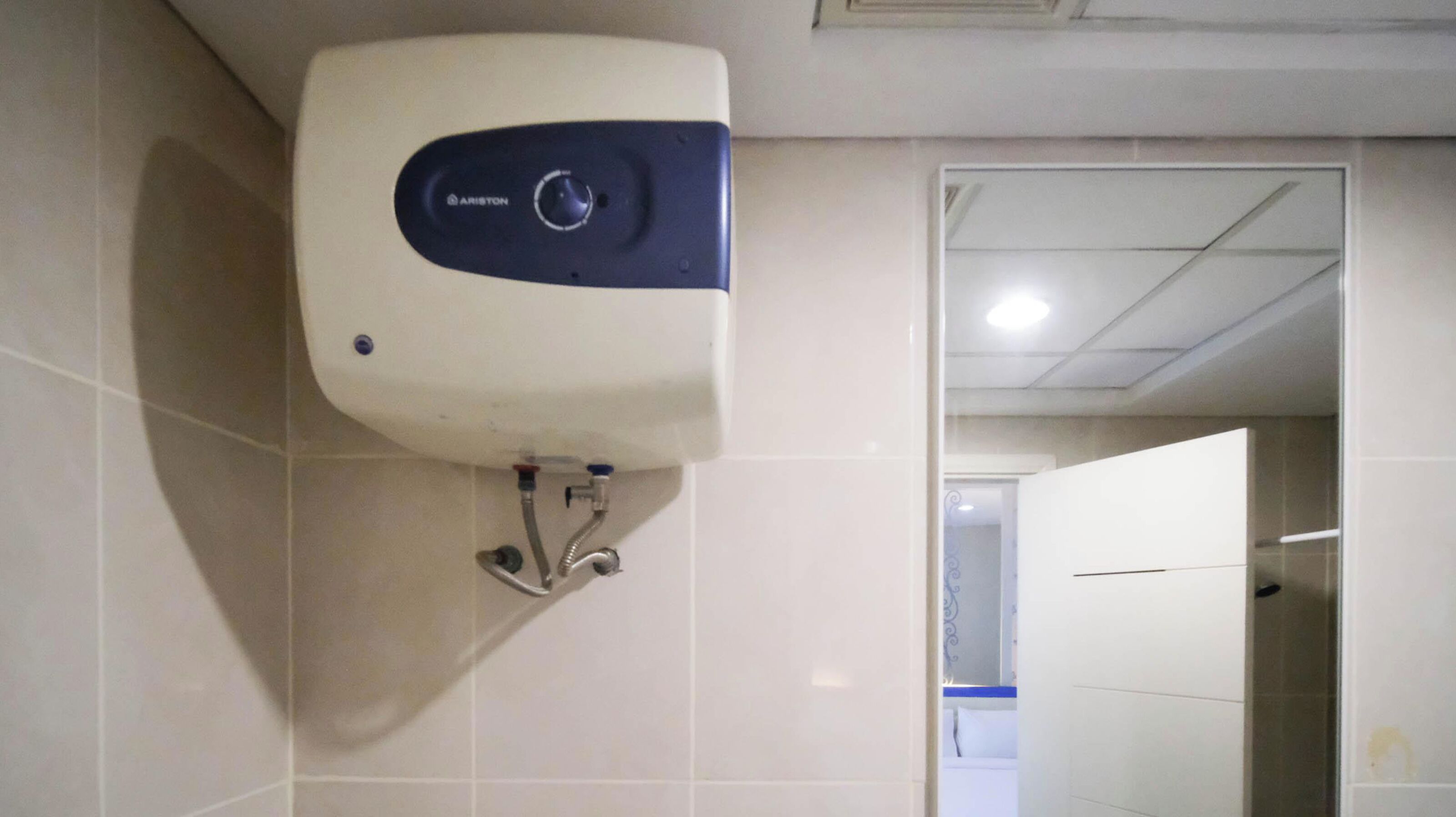 A hand dryer mounted on a wall in a restroom.