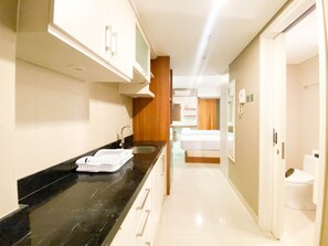 Studio | Private kitchen | Fridge, stovetop, rice cooker - Comfy And Minimalist Studio At Marquis De Lafayette Apartment (Semarang)