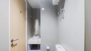A bathroom with a glass partition, a sink, a toilet, and a shower. - Simply Look And Comfort Studio Tree Park City Bsd Apartment (South Tangerang)