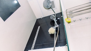 A bathroom with a shower, a toilet, and a sink. - Comfort And Warm Studio At Serpong Greenview Apartment (South Tangerang)
