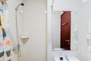A bathroom with a shower, a sink, a mirror, and a towel rack. - Modern Look 1Br At Asatti Apartment (Pagedangan)