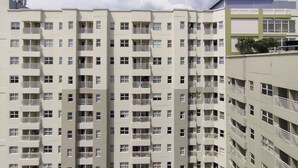 A multi-story residential building with balconies and a flat facade. - Stylish 1Br Apartment Parahyangan Residence (Bandung)