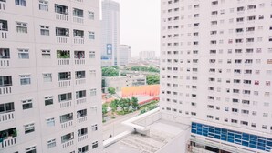 A high-rise building with multiple floors, large windows, and balconies.