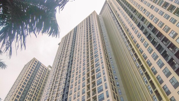 A high-rise building with multiple floors, featuring a grid-like window pattern and balconies. - Good Choice And Restful Studio At Transpark Cibubur Apartment Near Mall (Depok)