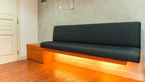 A modern room with a wooden bench, a white door, and a light-colored wall. - Good Deal And Comfortable 1Br The Boulevard Apartment (Jakarta)