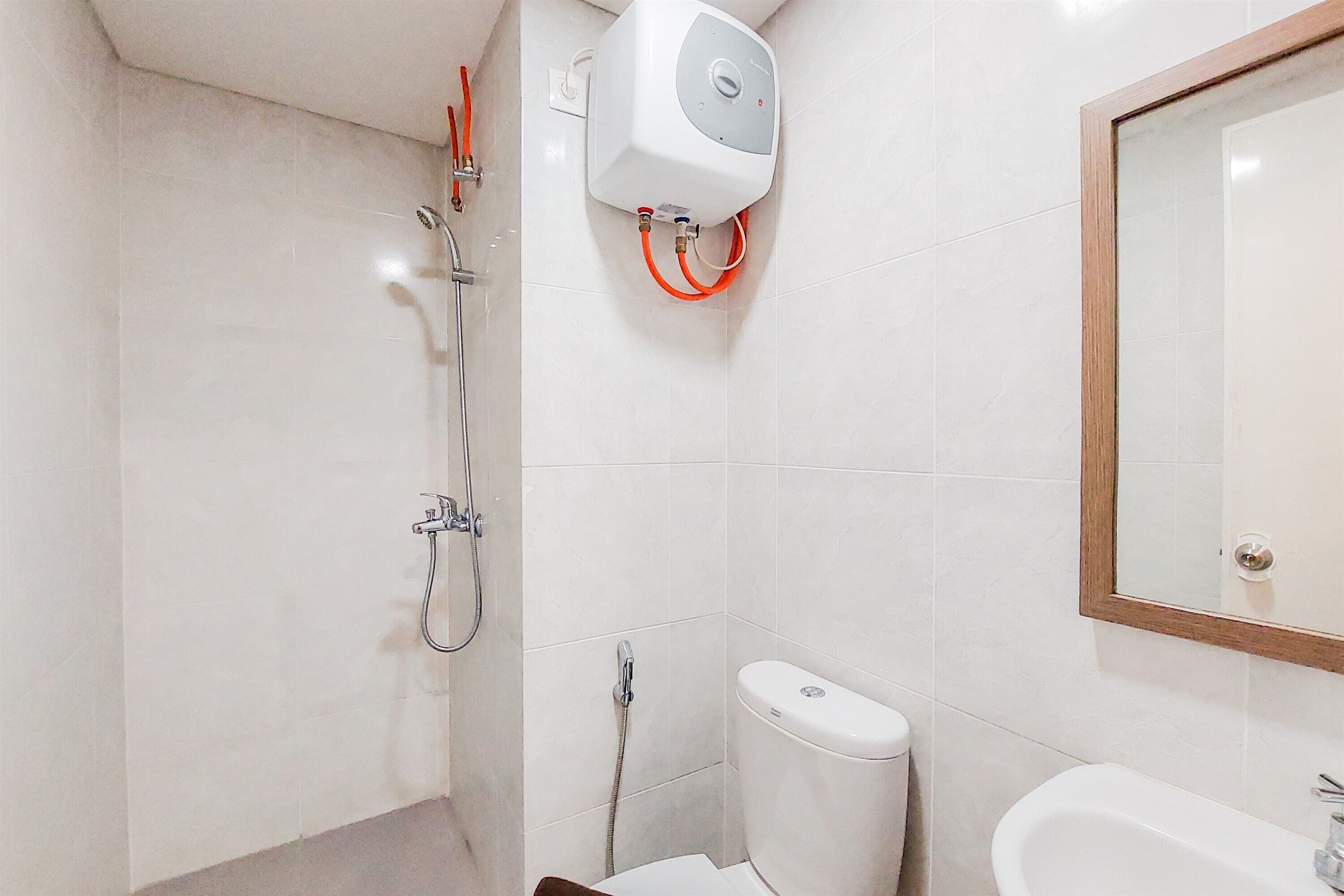 A bathroom with a shower, toilet, and sink.