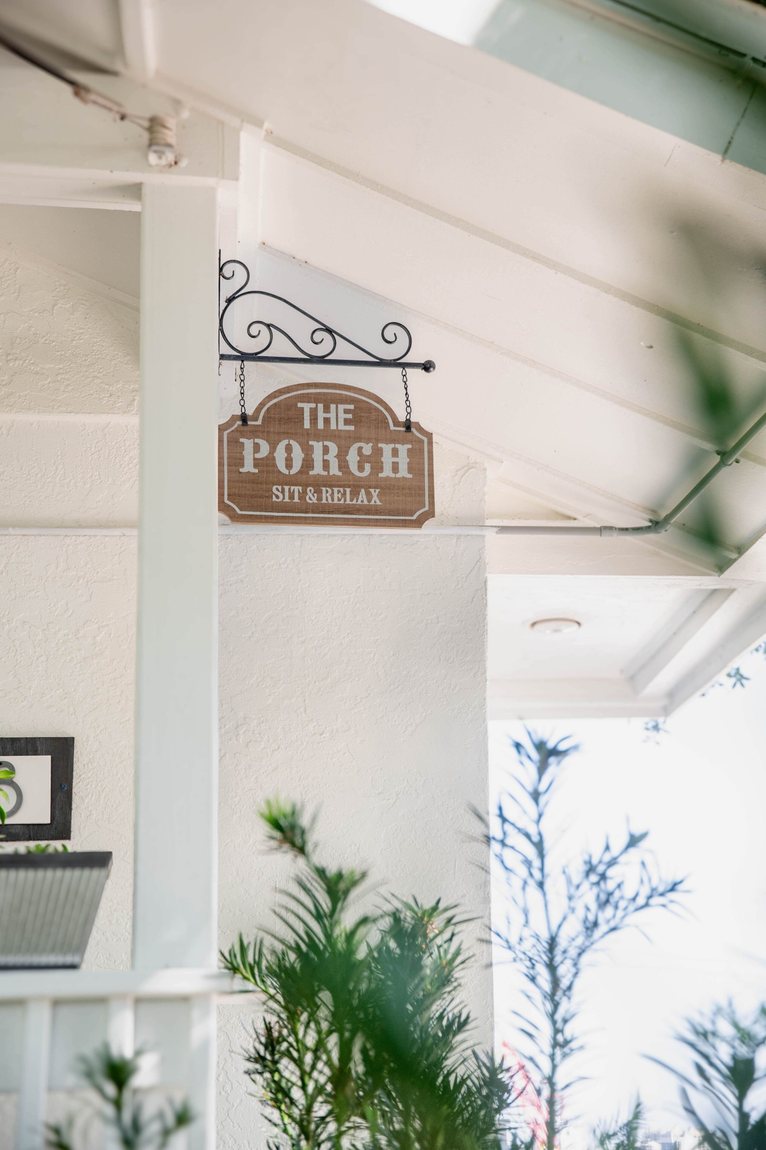 Un letrero que dice 'The Porch Sit & Relax' en la fachada de un edificio.