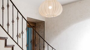A staircase with a metal railing and two hanging pendant lights. - Boutique HOH (Zagreb)