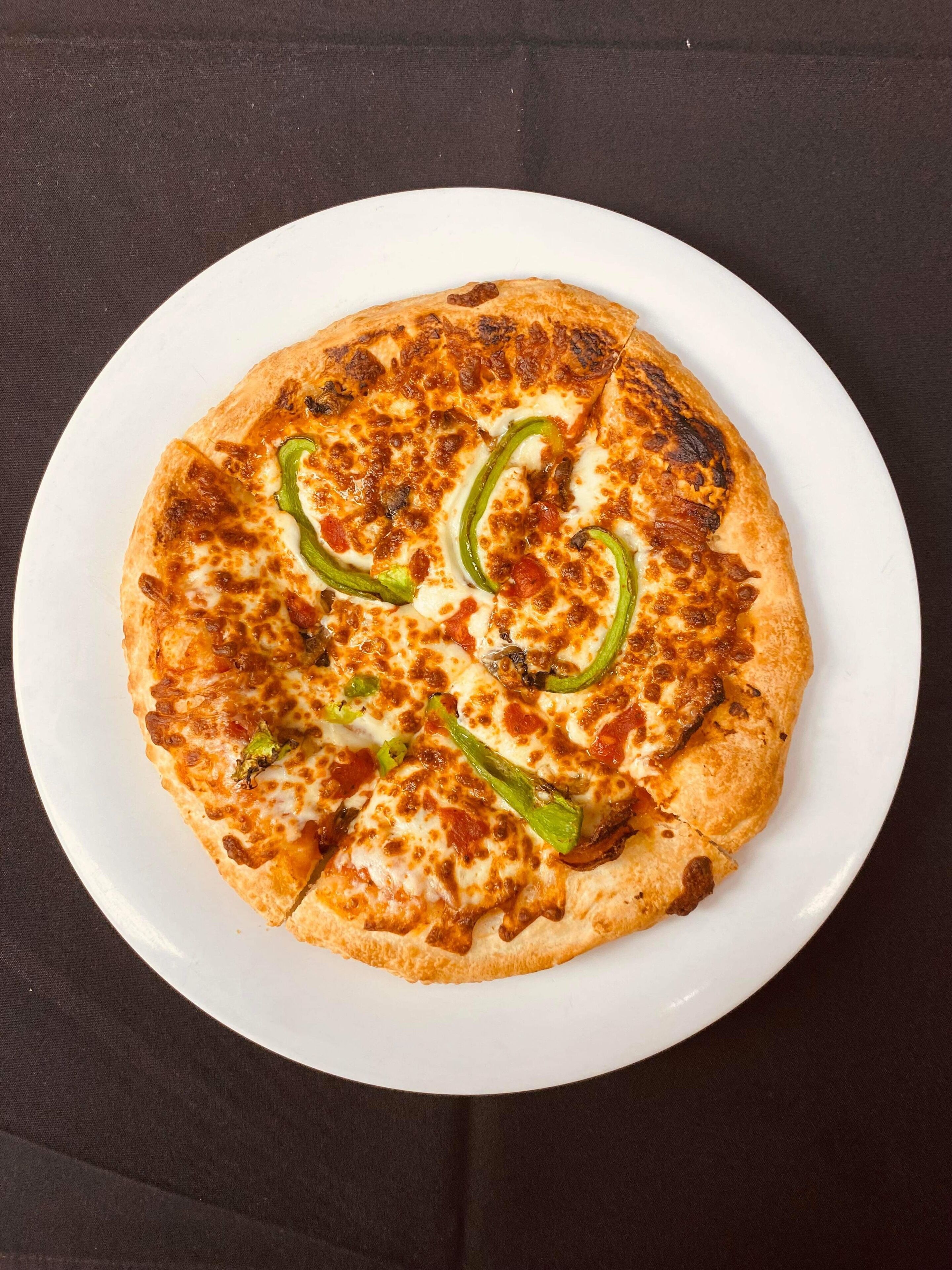A pizza on a white plate.