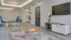 A modern hotel lobby with a reception desk, seating area, and a TV mounted on the wall. - Torre Palace II by Atlantic Holiday (Camara de Lobos)