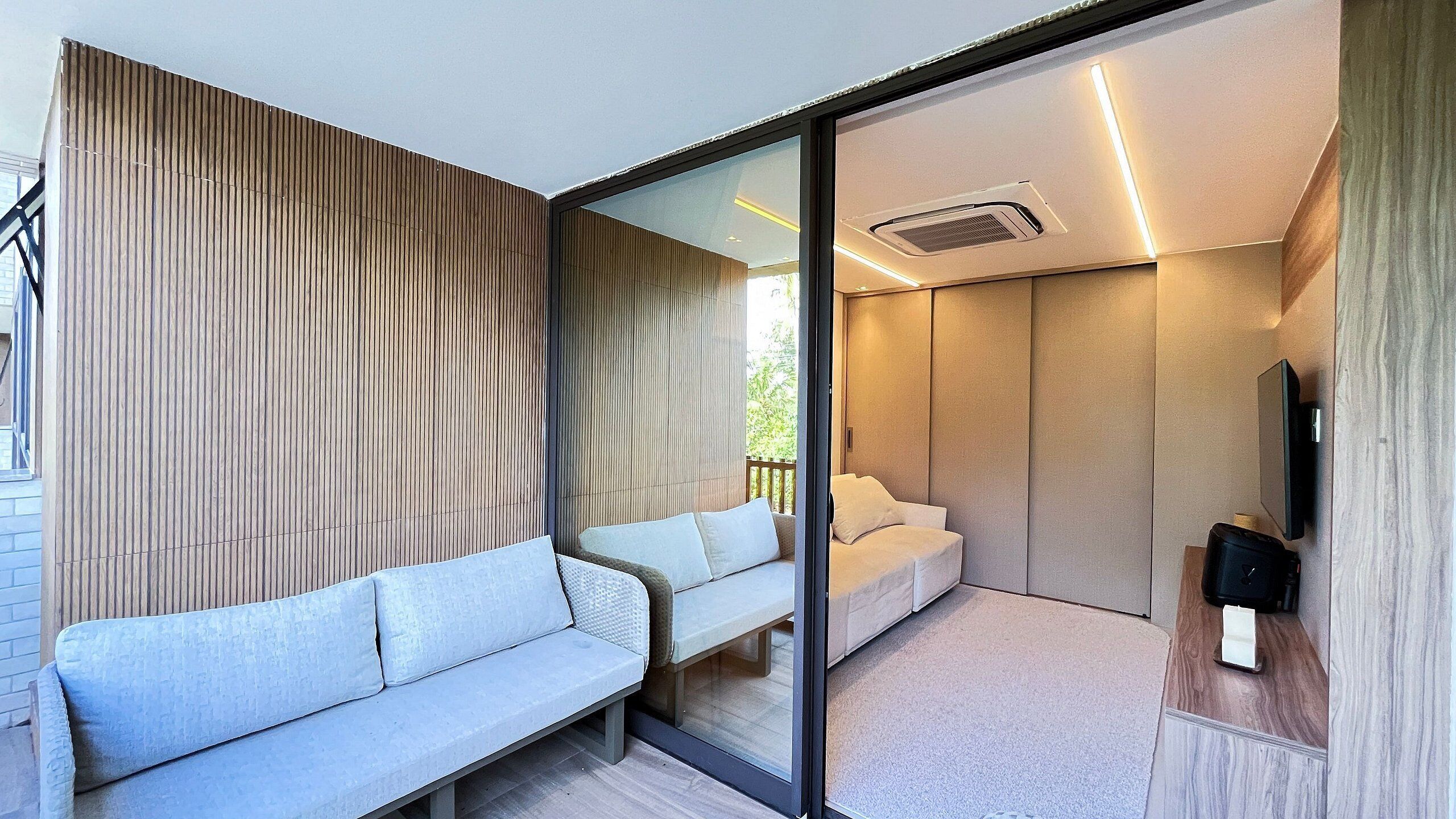 A modern room with a sofa, a bed, and a TV.