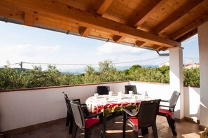 Enjoy dining al fresco in this serene outdoor patio with a table set for four.