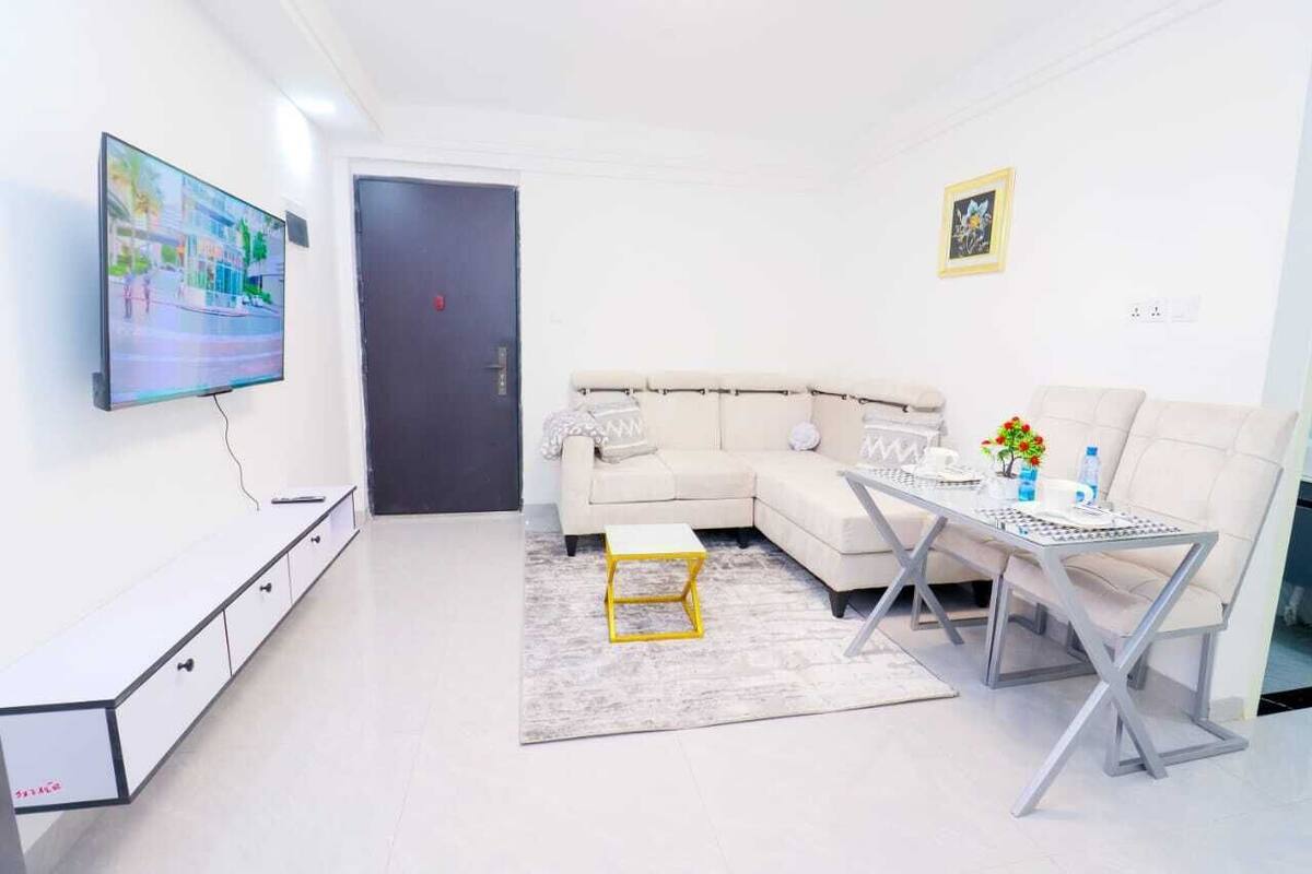A modern living room with a sofa, coffee table, and TV.