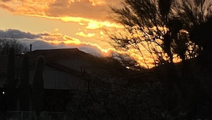 A sunset with clouds over a residential area.