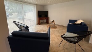 A living room with a TV, two sofas, and a coffee table.