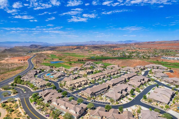 A residential area with houses arranged in a grid pattern, roads, and a distant mountain range. - Spacious, Clean Coral Ridge Townhome (Washington)