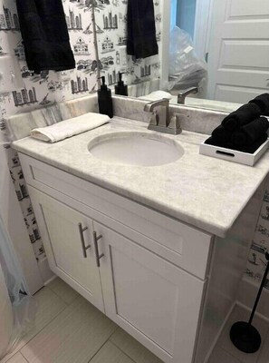 Shower, hair dryer, towels, toilet paper