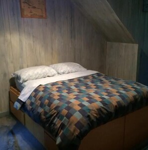 Cozy retreat with a single bed and sloped ceiling.