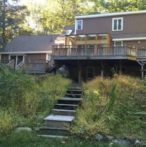 Enjoy the elevated views from the upper deck, surrounded by lush vegetation.