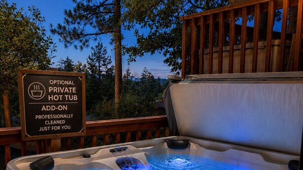 A hot tub with a sign indicating it is an optional, private, professionally cleaned add-on.