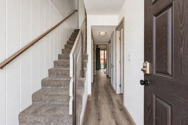 Bright neutral entryway and staircase (1)