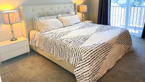 A neatly made bed with a striped bedspread, two bedside lamps, and a window with blinds. - Peaceful 3bed3bath 2300sqft Home Centrally Located in Heart of Silicon Valley (Santa Clara)