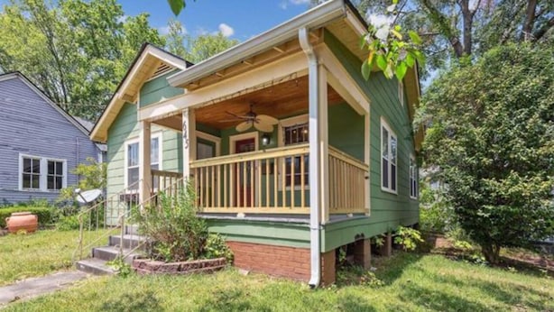 A two-story house with a front porch, a satellite dish, and a brick foundation. - TigerTown Retreat. Downtown Baton Rouge and 5 minutes to LSU. (Baton Rouge)