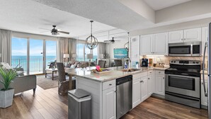 A modern kitchen with white cabinets, stainless steel appliances, and a large island. - Majestic Sun A404*Remodeled*Gulf Views*HeatedPools*Hot Tubs*Beach Gears (Miramar Beach)