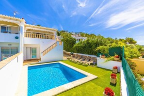 A pool area with a clear blue pool, sun loungers, and a staircase leading to a second floor. - 3 Bedroom Villa, Private Pool, San Jaime, Son Bou (San Jaime Mediterraneo)