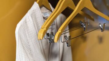 A clothing rack with hangers and a folded garment.