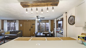 A kitchen with a central island, wooden ceiling, and pendant lights. - Charming Cottage on a hill by Camelback and Kalahari (Long Pond)