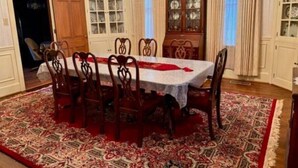 A dining room with a large table, chairs, a chandelier, and a patterned rug. - Victorian Oasis home in Mineral City, near Atwood - Deer Hunting -  Hot Tub (Mineral City)