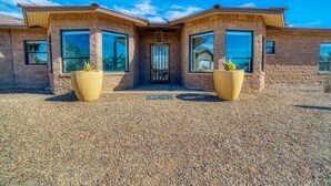 A modern house with a symmetrical design, featuring large windows and a central entrance. - Event Ready Spacious Tucson Villa w/ Private Pool (Tucson)