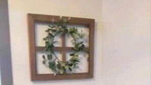 Et træspisebord med et skakspil, en billedramme med en plante og en lille æske på bordet.