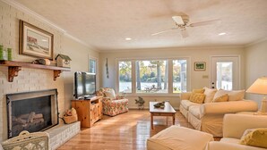 A cozy living room with a fireplace, a television, a sofa, and a coffee table. - RivahMojo on Mill Creek-just off RappahannockRiver (Topping)