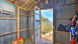 A rustic cabin with a wooden deck, fishing rods, and life jackets. - RivahMojo on Mill Creek-just off RappahannockRiver (Topping)