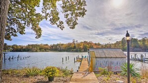 A wooden dock leading to a small building by a lake with a clear sky. - RivahMojo on Mill Creek-just off RappahannockRiver (Topping)