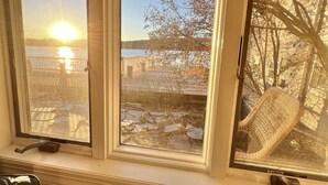 Three windows with a view of a dock and a body of water.