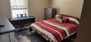 Cozy retreat with a bed, desk, and storage for a productive stay.
