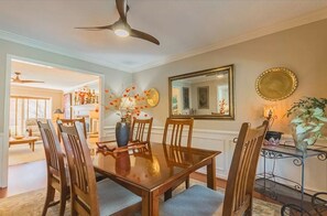Enjoy meals in this cozy dining area with a wooden table and six comfortable chairs.
