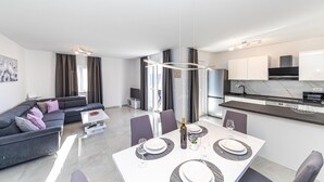 A modern apartment with a living room, dining area, and kitchen. - 2 bedroom awesome apartment in Okrug Gornji (Okrug Gornji)
