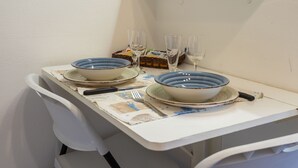A dining table with two bowls, a fork, a knife, and two glasses. - Studio Apartment "Casa Loredana" with Private Terrace & Wi-Fi (Venezia)