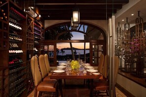Enjoy meals in this elegant dining area with a large table, comfortable chairs, and a beautiful view of the surrounding mountains.
