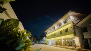 A building with a ground floor cafe, outdoor seating, and a staircase to the upper floor. - Villa Soledad Garden Resort (San Pablo)