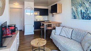 A compact living space with a kitchenette, a sofa, a coffee machine, and a television. - 01426 _ Apartment 4 people, residence with pool, Lacanau Ocean (LACANAU OCEAN)