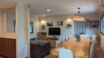 Villa | Living area | 57-inch flat-screen TV with cable channels