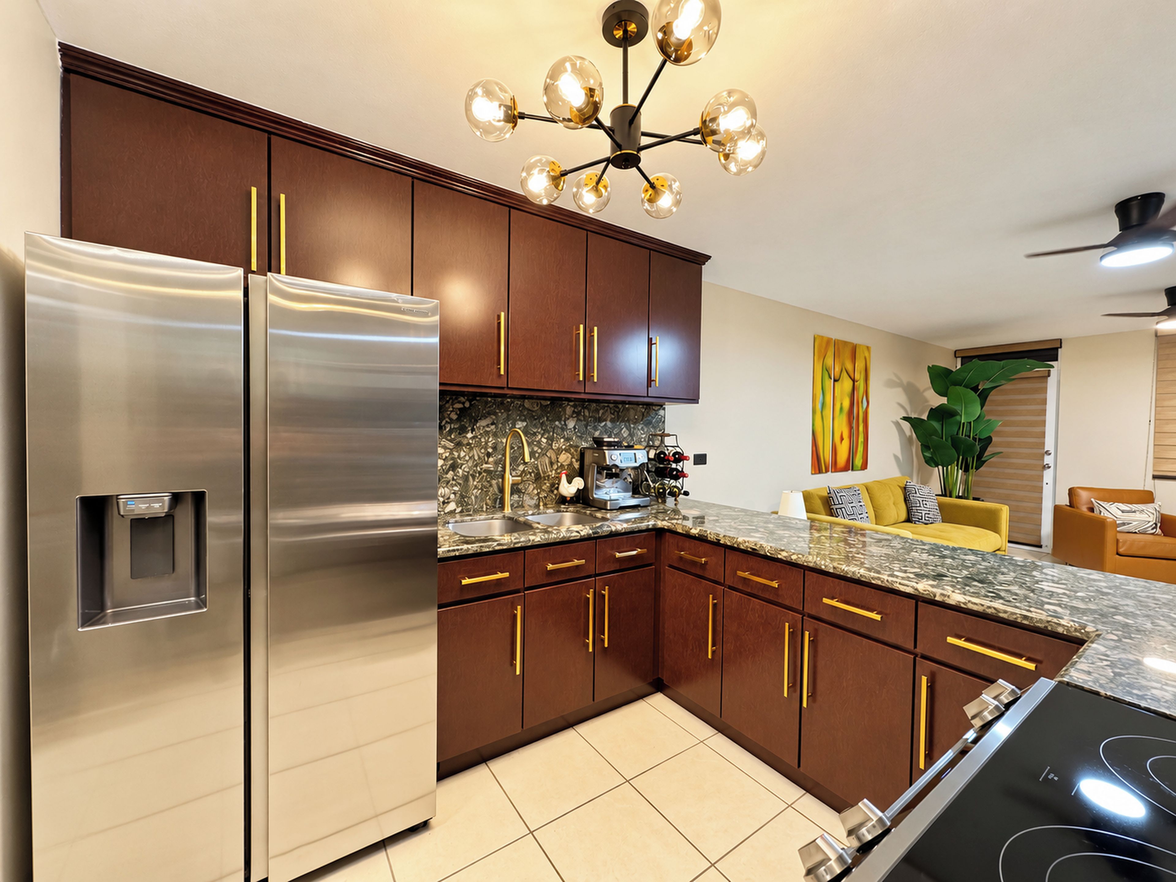 A modern kitchen with stainless steel appliances, wooden cabinets, and a granite countertop.