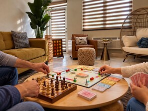 A living room with a chessboard, a board game, and a plant. - Rincon Ocean Views and Sunsets, 2 King Beds, Pool, Beach Across the Road (Rincón)